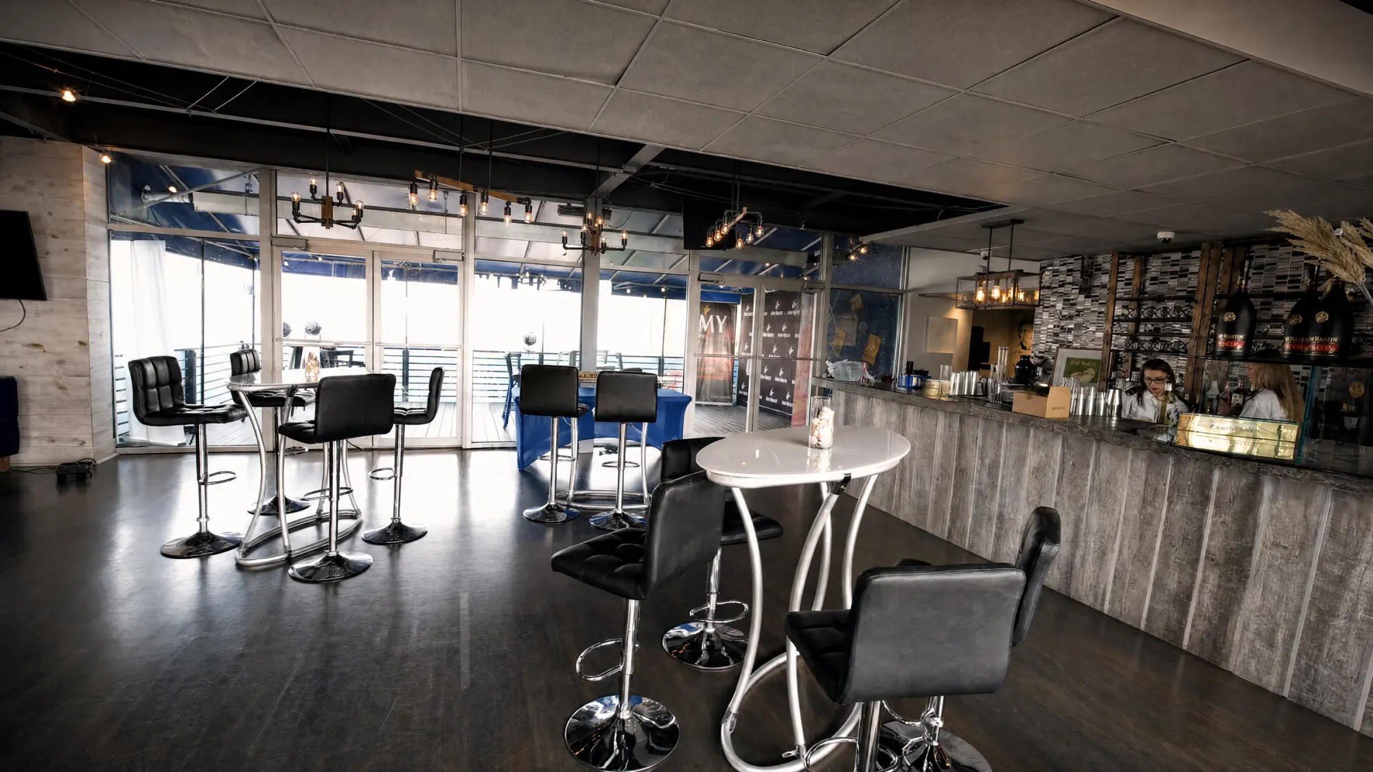 The Club's own bar and the glass doors open to the private deck overlooking the water