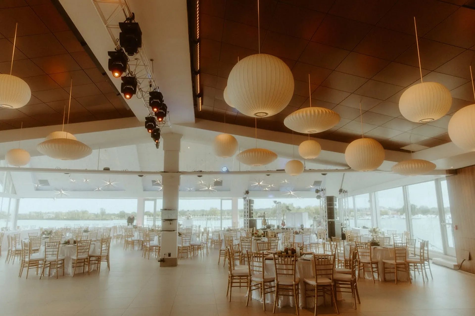 Corporate event space in Michigan set with round tables at golden hour