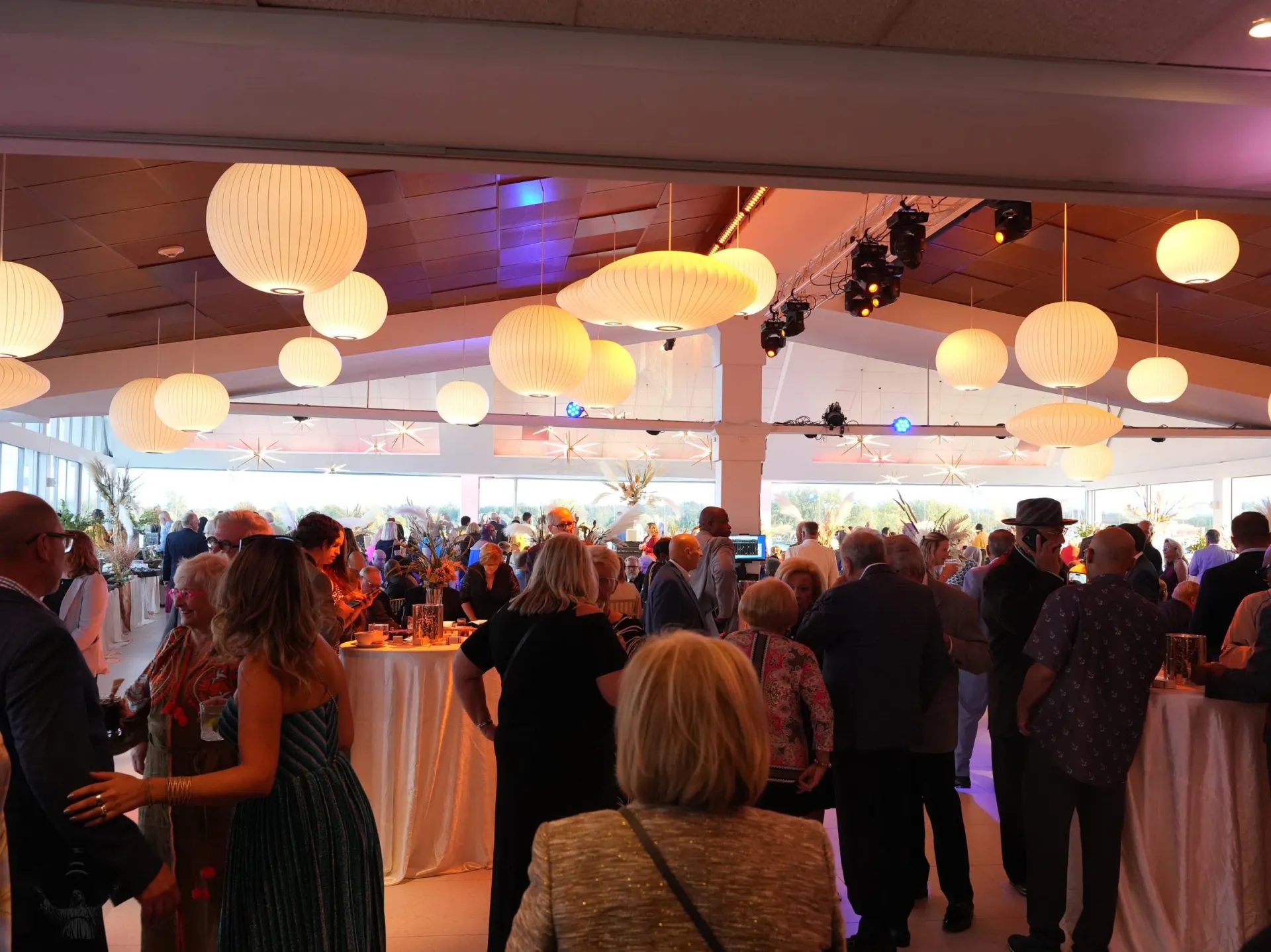 Cocktail hour at a Detroit corporate event venue under paper lanterns