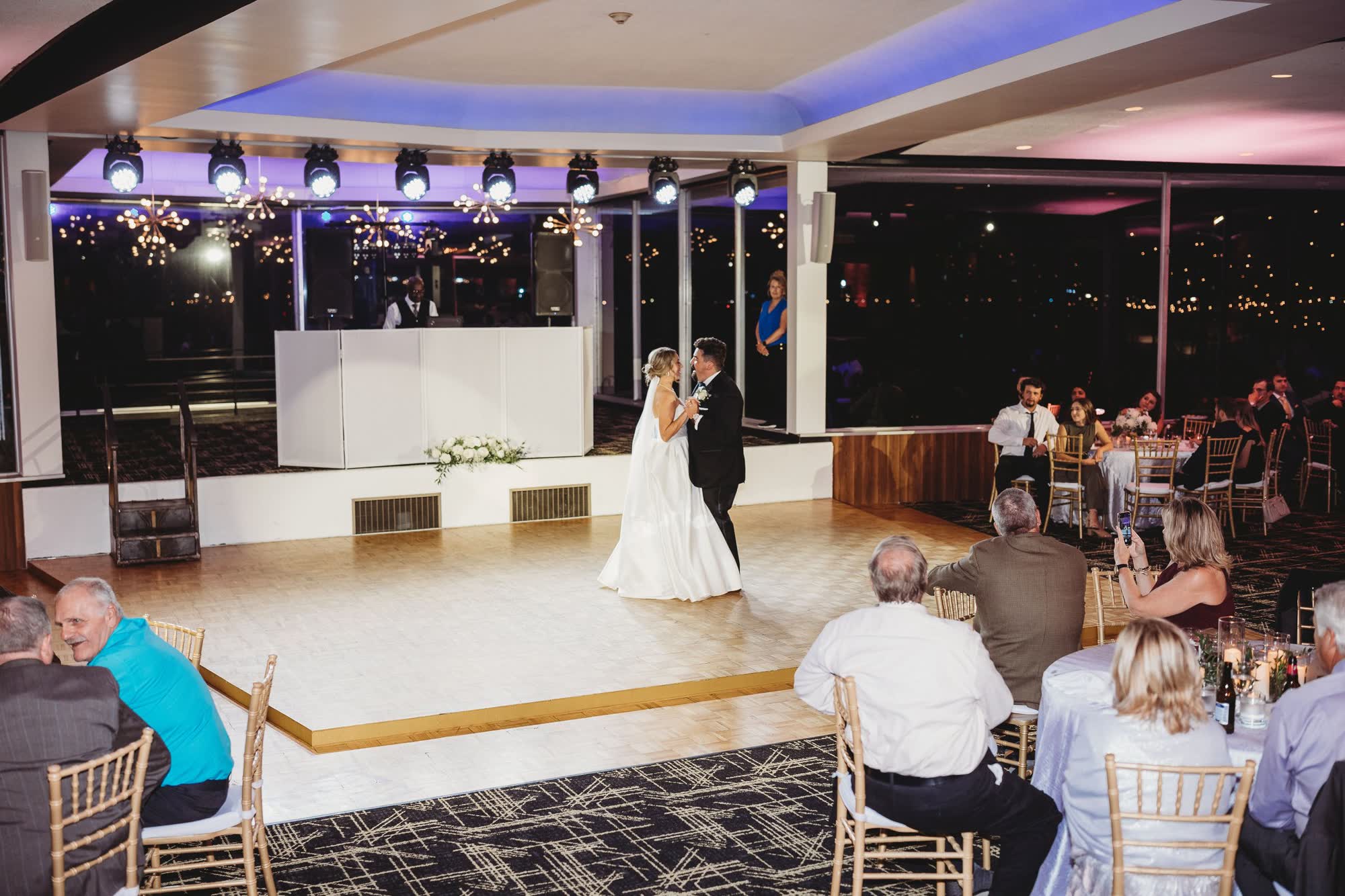 Dance floor under blue and purple uplighting at a Detroit riverfront prom venue