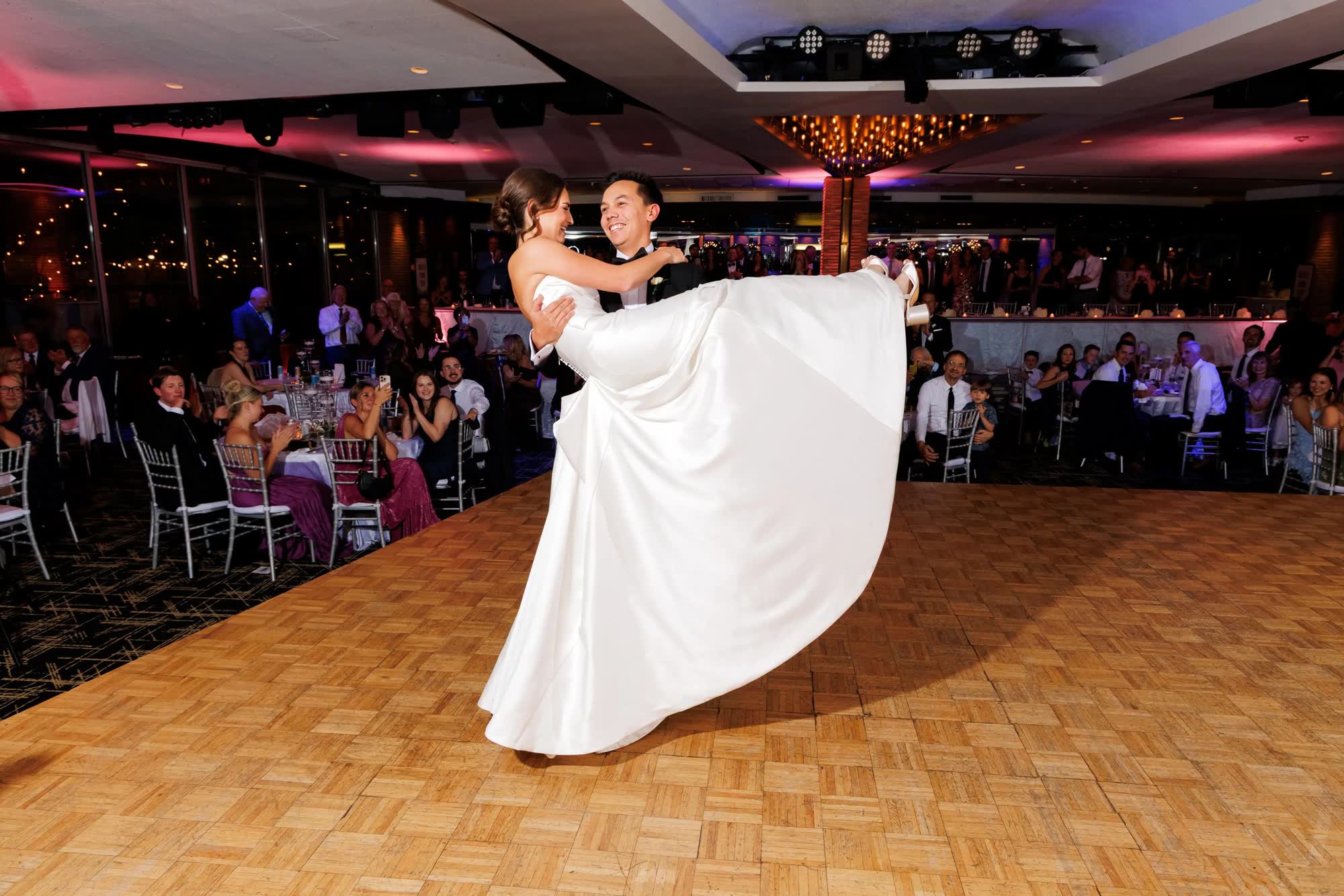 First dance surrounded by guests in the ballroom