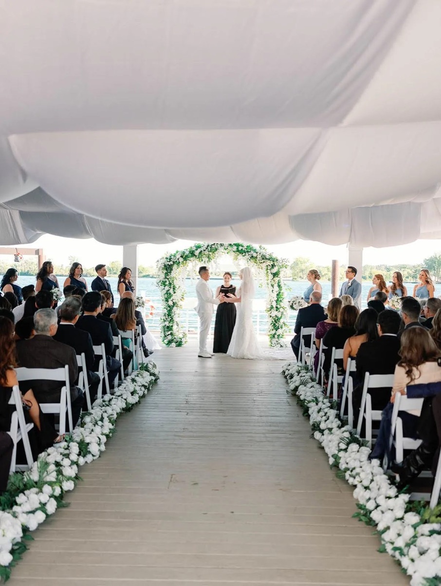 Wedding ceremony aisle on the dock at The Roostertail, Detroit River behind